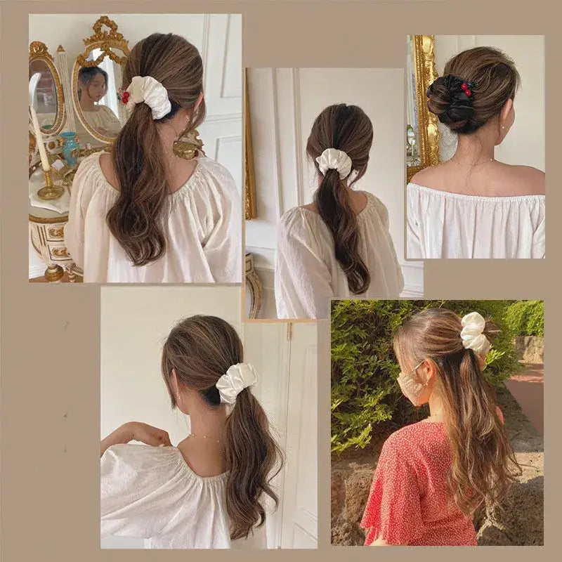 Wavy brown ponytail secured with a white scrunchie or hair tie.