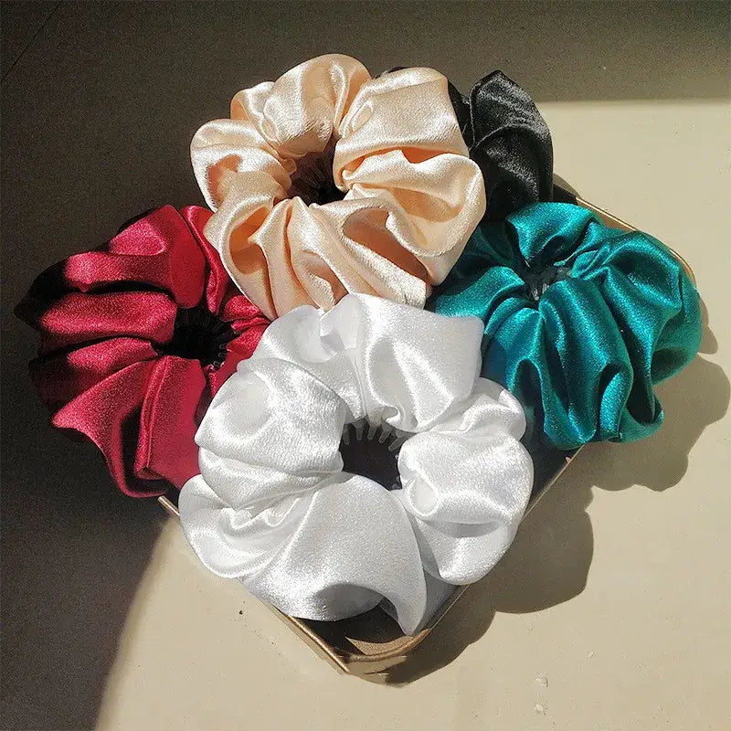 Collection of satin hair scrunchies in red, white, beige, black and teal colors.