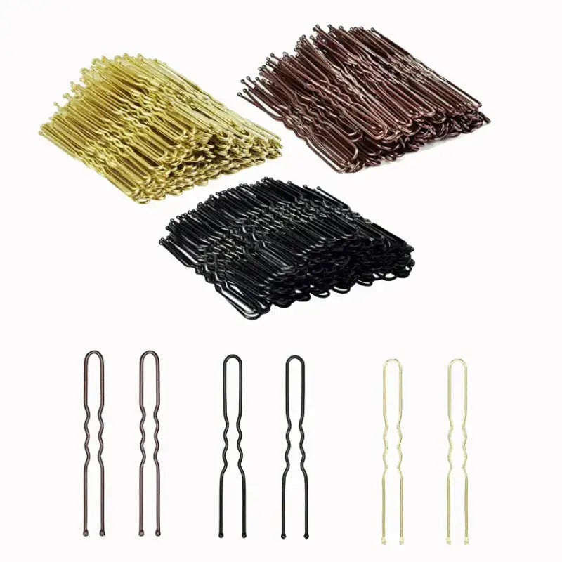 Hair pins in gold, brown, and black colors arranged in groups.
