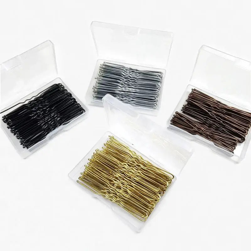 Bobby pins in different metallic colors arranged in clear plastic cases.