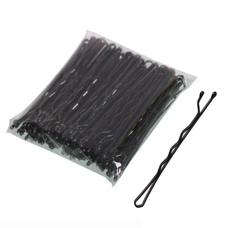 Black metal bobby pins packaged in a clear plastic bag.