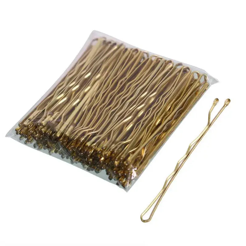 Gold-colored metal bobby pins arranged in a pack.