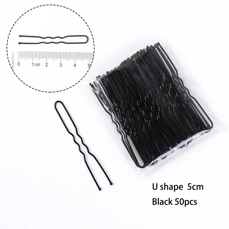 Black U-shaped hair pins arranged in a bundle.
