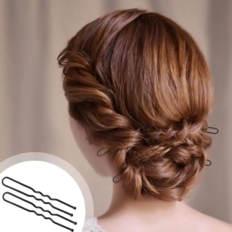Elegant braided updo hairstyle secured with bobby pins.
