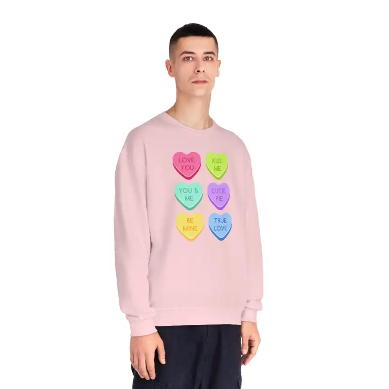 Pink sweatshirt featuring colorful candy heart designs arranged in a grid pattern.