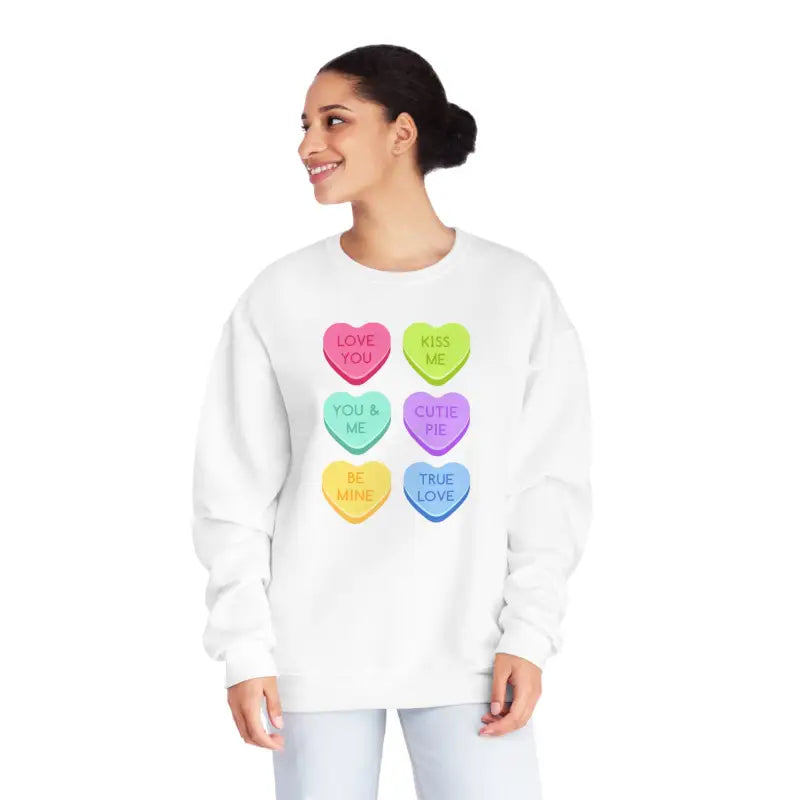 White sweatshirt featuring six colorful candy heart designs with text messages printed on them.