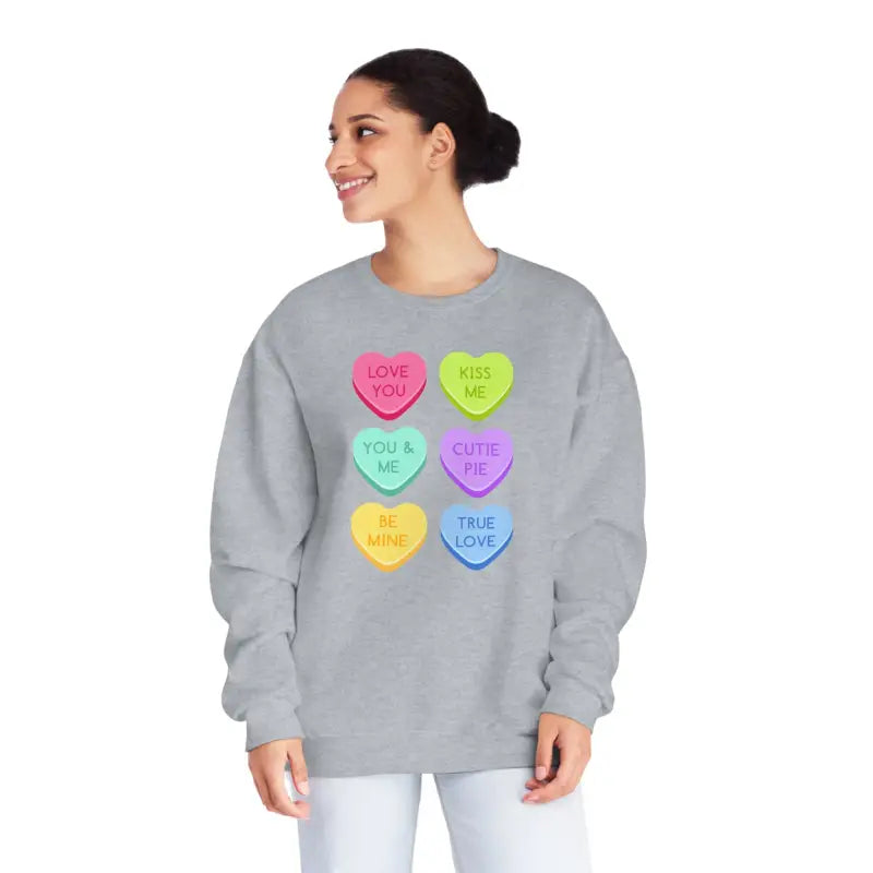 Grey sweatshirt featuring colorful candy heart designs with text messages printed on them.