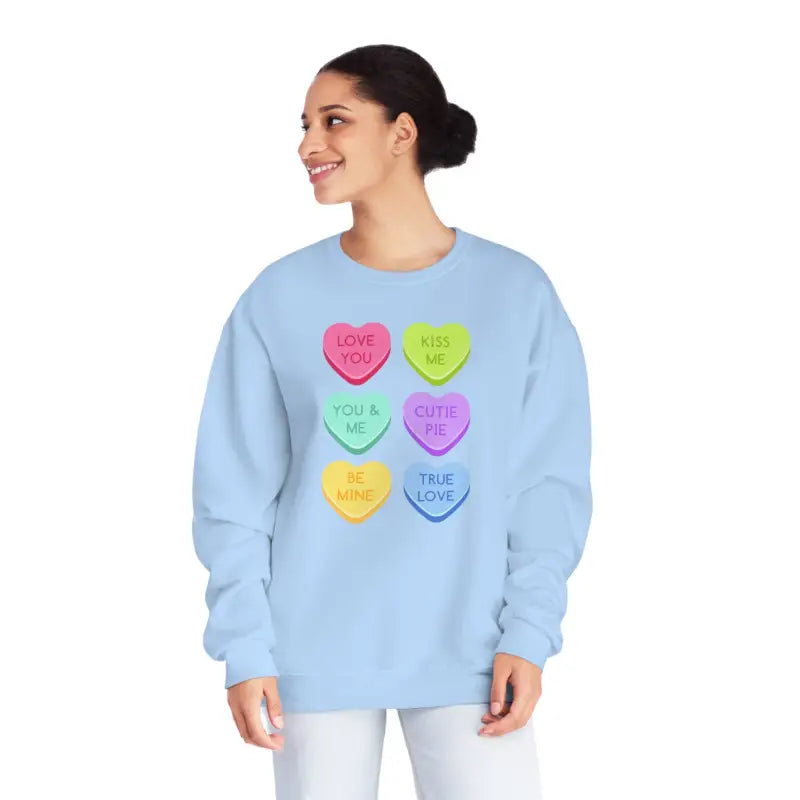 Light blue sweatshirt featuring colorful candy heart designs with text.
