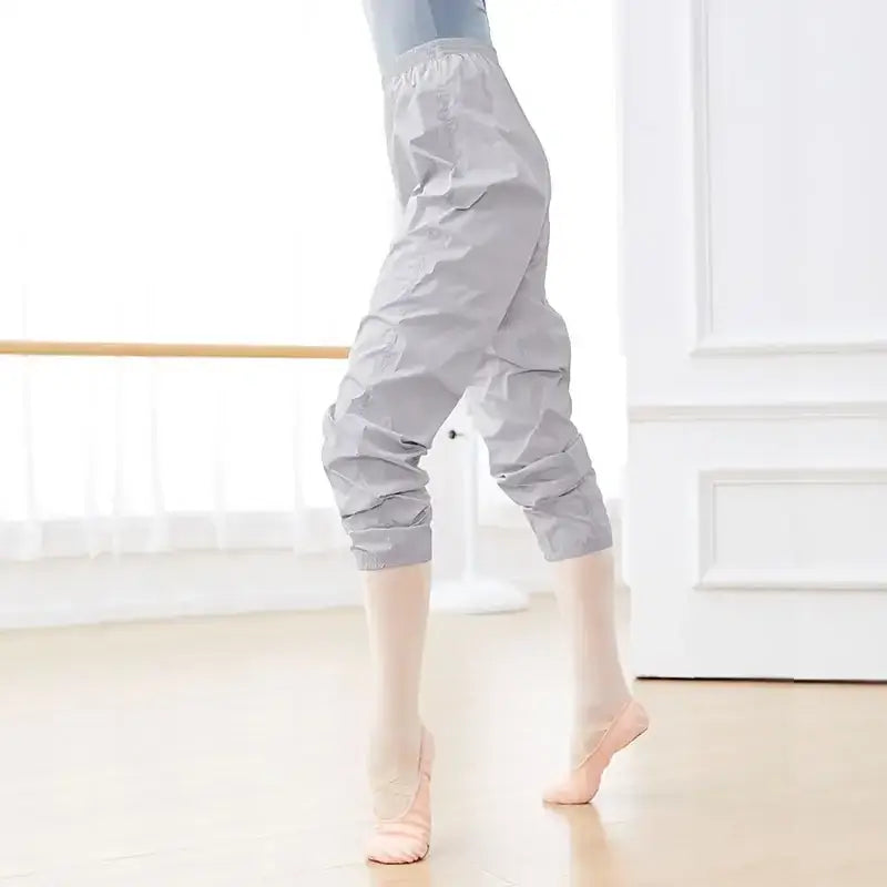 Gray cropped jogger pants with elastic cuffs.