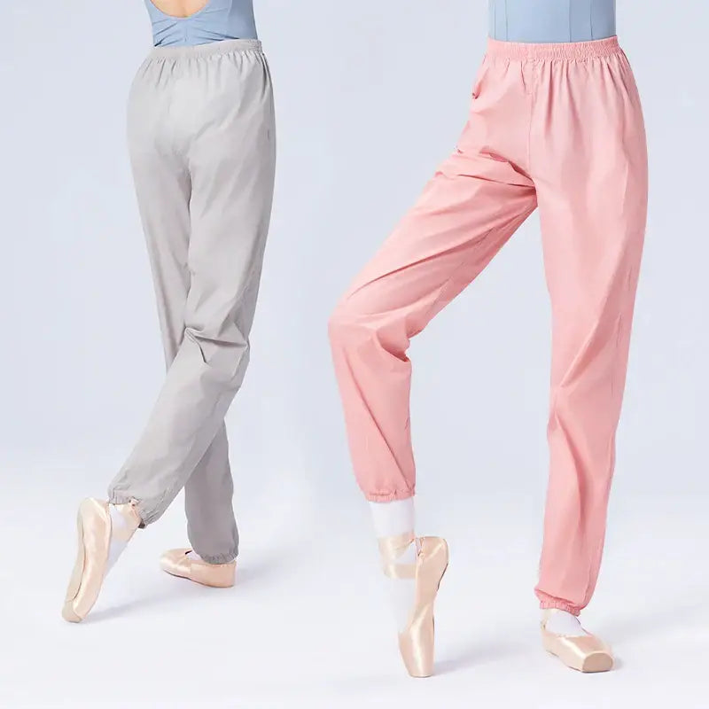 Ballet warm-up pants in gray and pink shown on dancers en pointe.