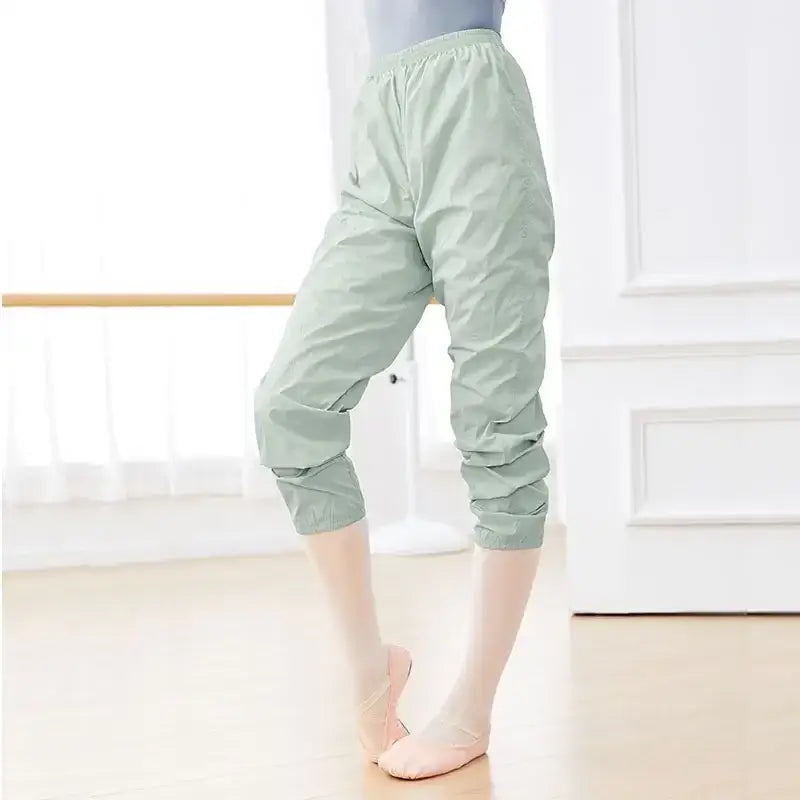 Mint green cropped jogger pants with elastic cuffs.