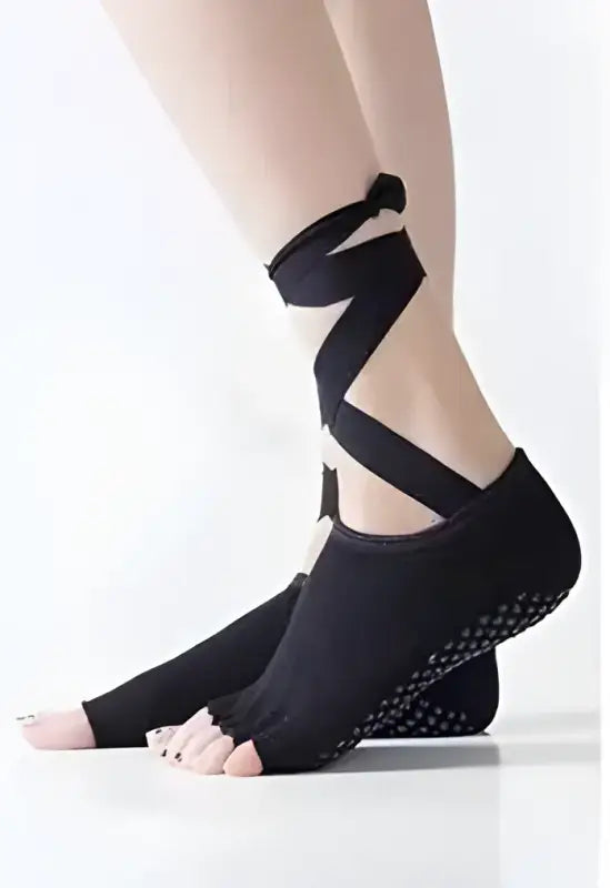 Black toe-separating yoga socks with ankle straps.