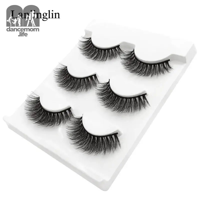 False eyelashes on a white tray.