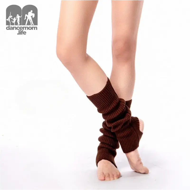 Brown knitted leg warmers worn over bare feet.