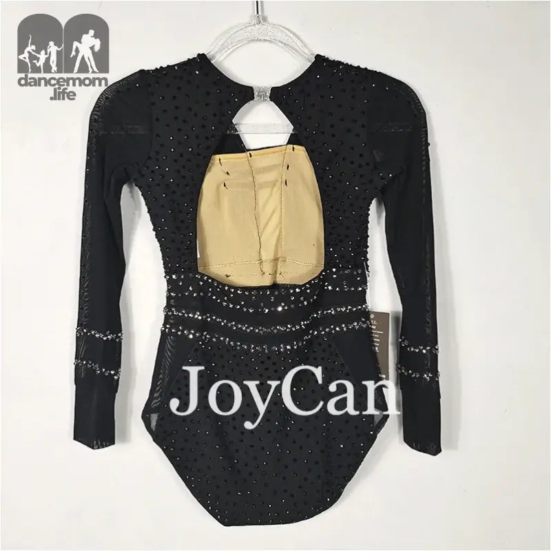 Black sparkly long-sleeved leotard with ’JoyCam’ text and a beige cutout detail.