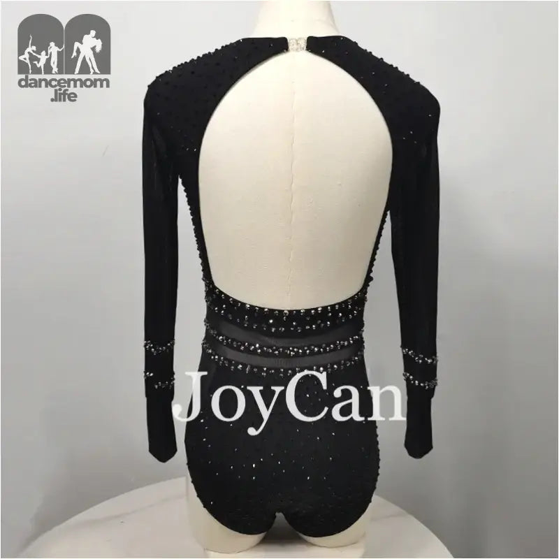 Black backless leotard with long sleeves and crystal embellishments.