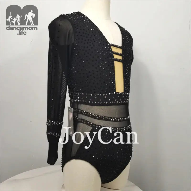 Black sparkly long-sleeved gymnastics leotard with mesh cutout details.