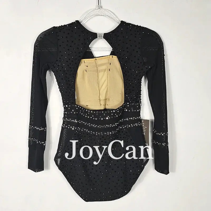 Black sparkly long-sleeved leotard with ’JoyCam’ text and a beige cutout detail.