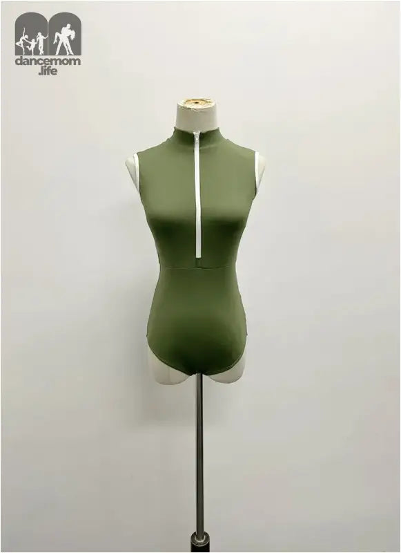 Olive green sleeveless bodysuit with white zipper detail on mannequin form.