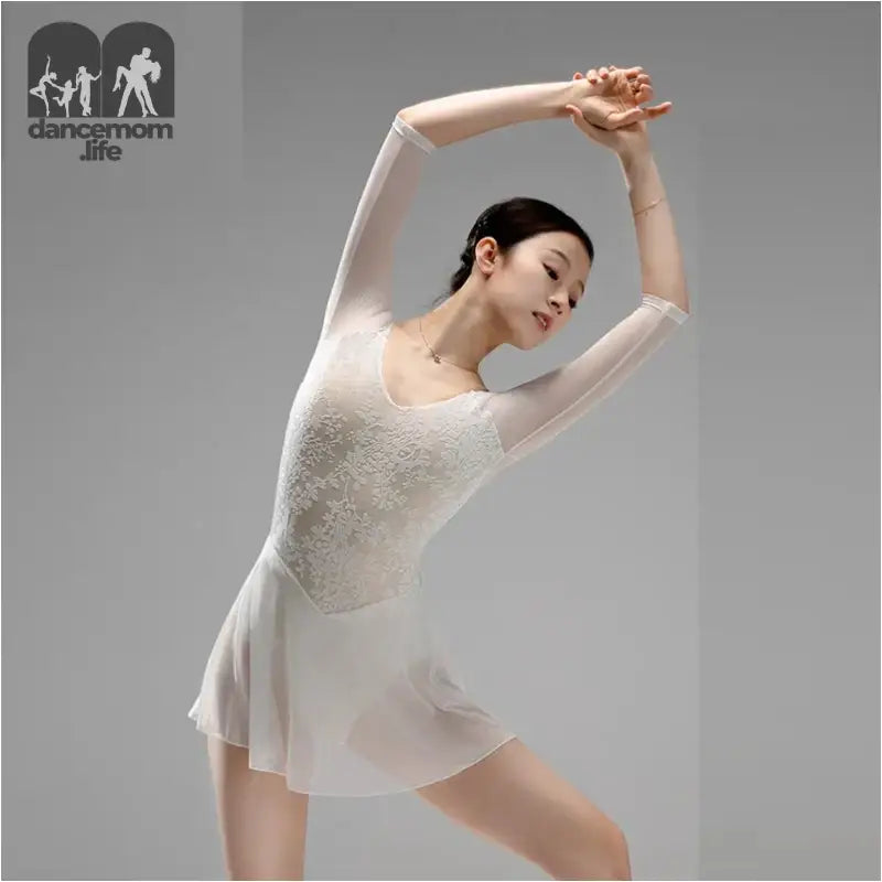 Graceful dancer in a white sheer leotard performing an elegant stretching pose.