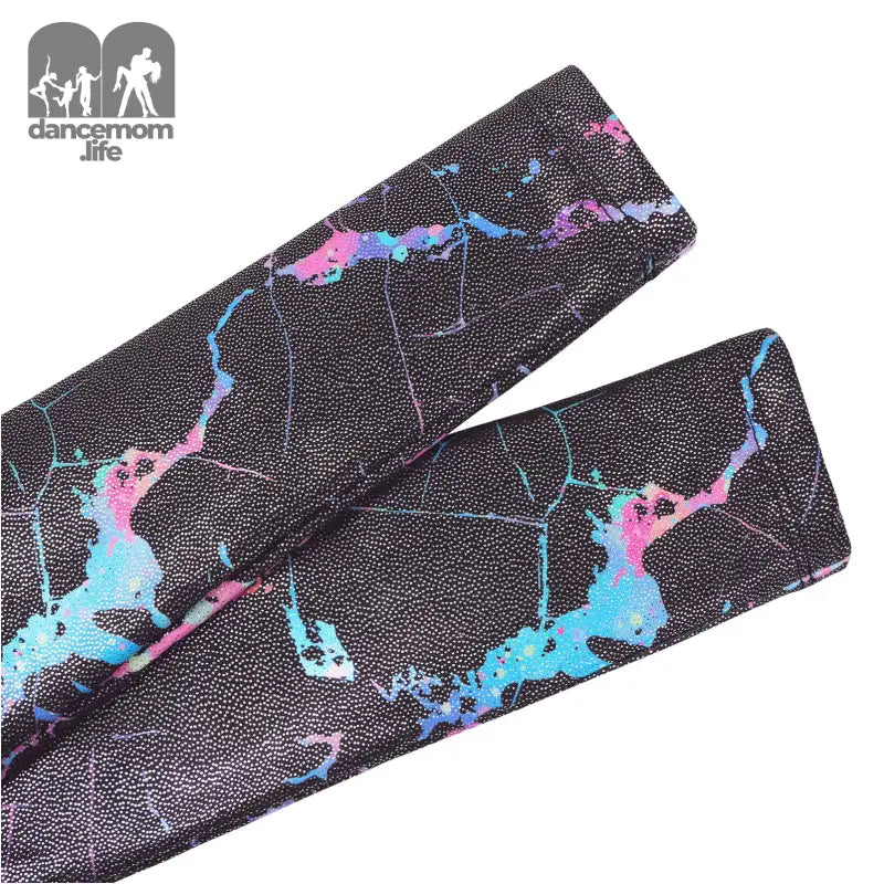 Black cricket bat grip with blue and pink marble-like pattern.