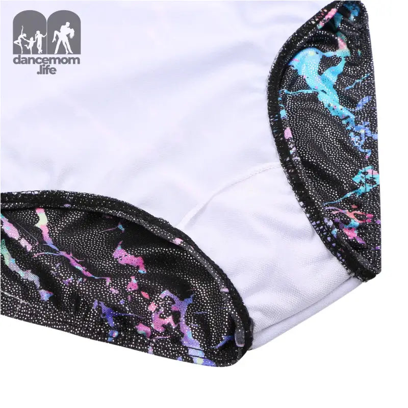 White fabric with black lace trim featuring iridescent blue, pink and purple accents.