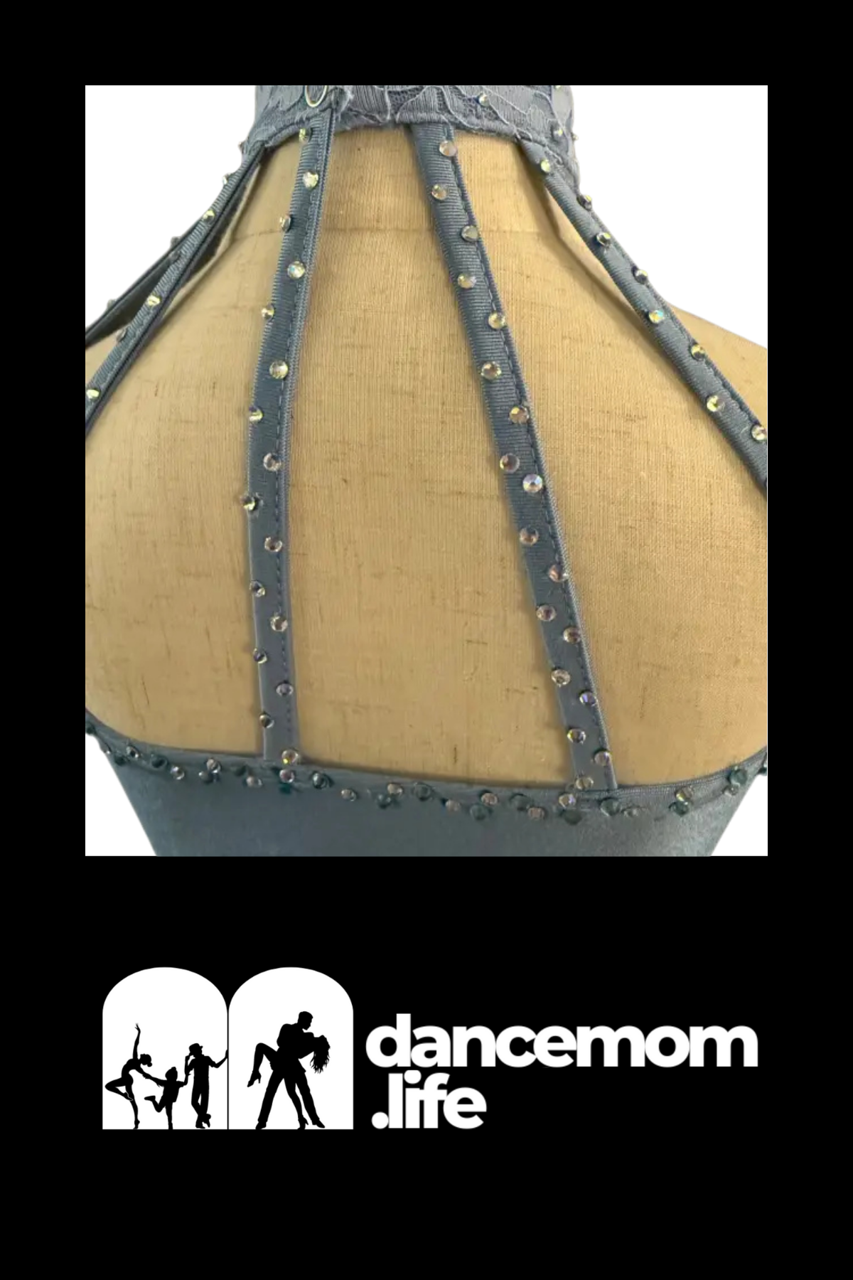 Gray satin ribbon straps with silver rhinestone embellishments adorn the back of a dance costume.