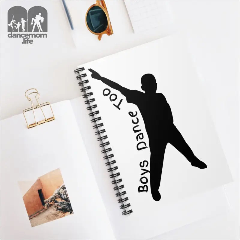 Spiral notebook with a black silhouette of a dancer and ’Boys Dance Too’ text on the cover.