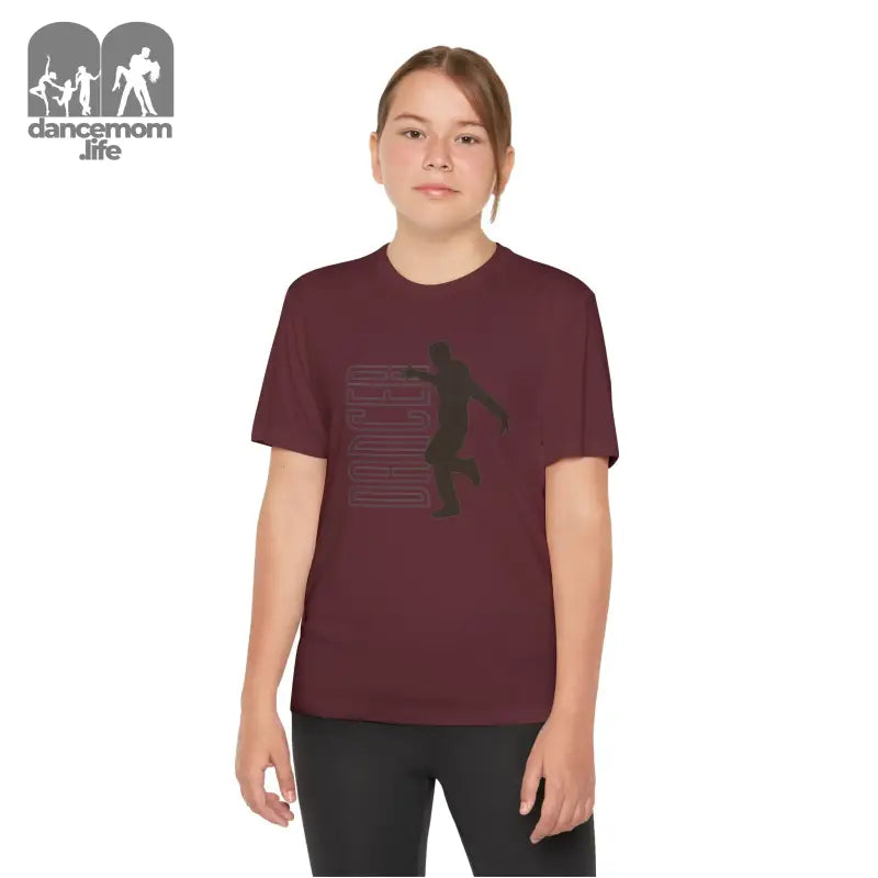 Burgundy t-shirt with a basketball player silhouette graphic design.