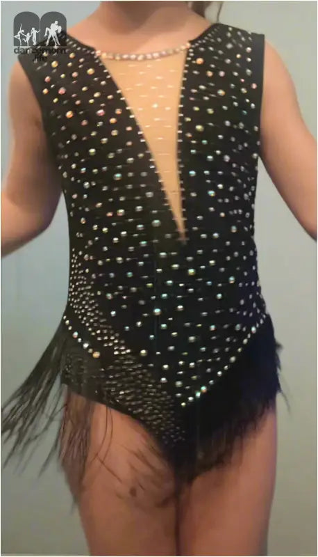 Sparkly black leotard with a plunging neckline and fringed bottom.