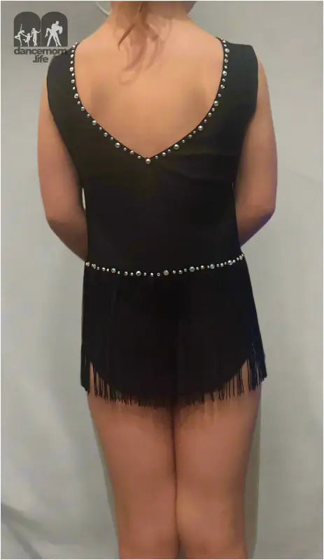 Black sleeveless dress with fringe hem and rhinestone trim.