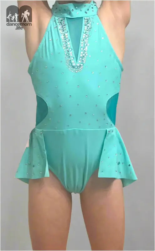 Turquoise figure skating dress with rhinestone accents and a halter neckline.