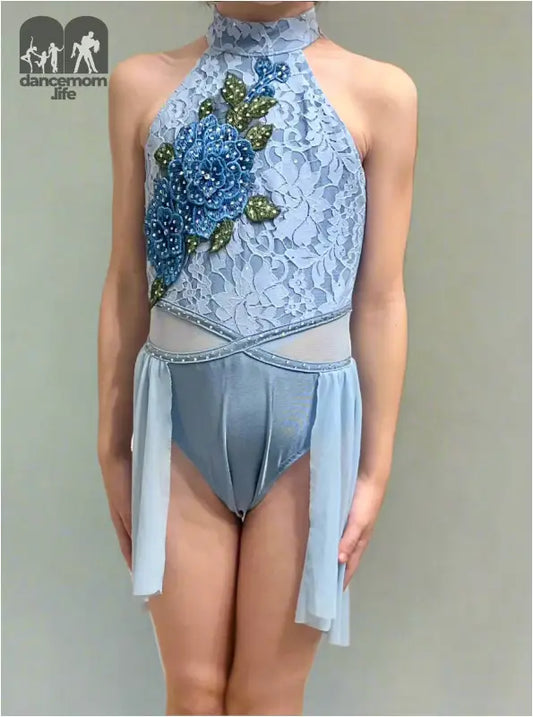 Pale blue figure skating costume with floral embroidery and sheer skirt panels.