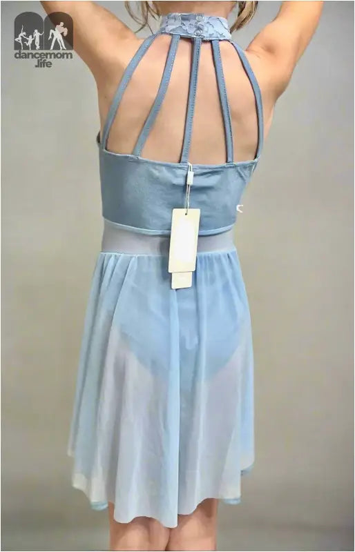 Light blue halter-style dress with a cage-like back design and a price tag attached.