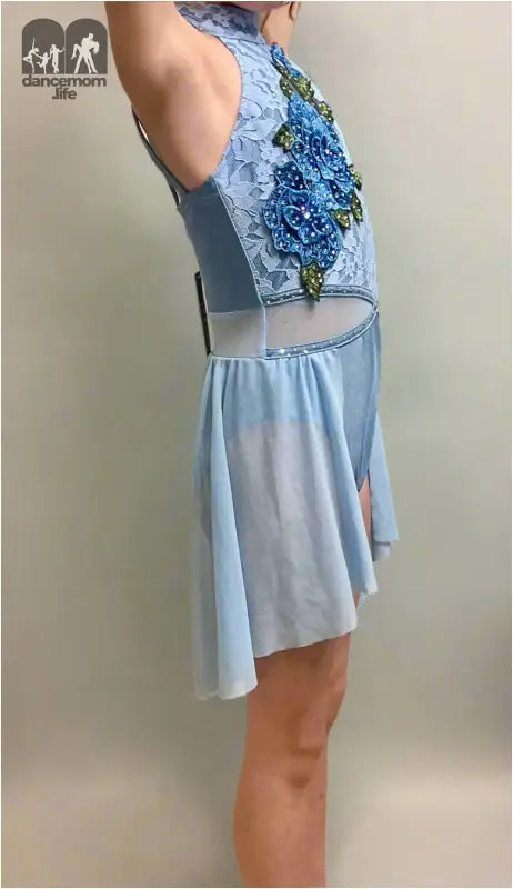 Light blue dress with floral embellishments on the bodice.