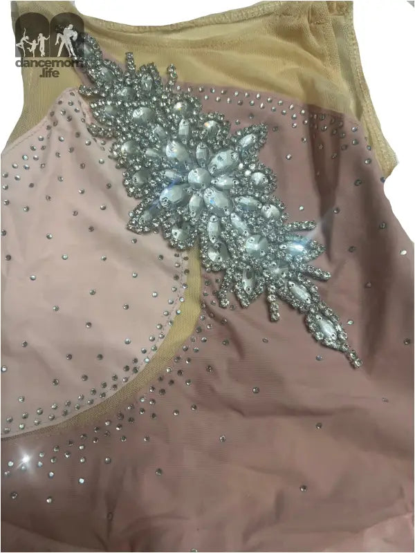 Embellished leotard or dance costume with sparkly floral appliqué and rhinestones.