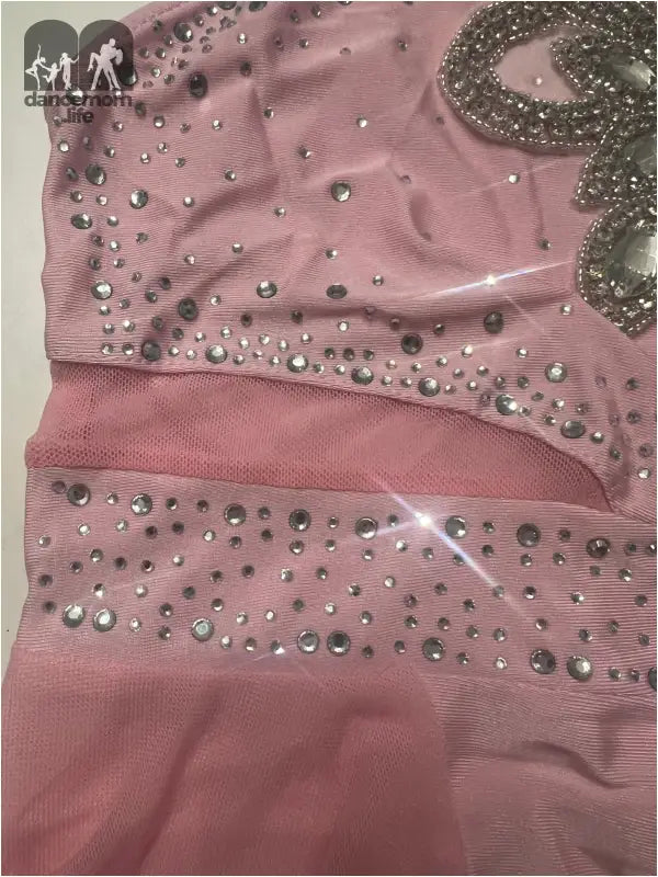 Pink fabric garment adorned with sparkling rhinestones or sequins.