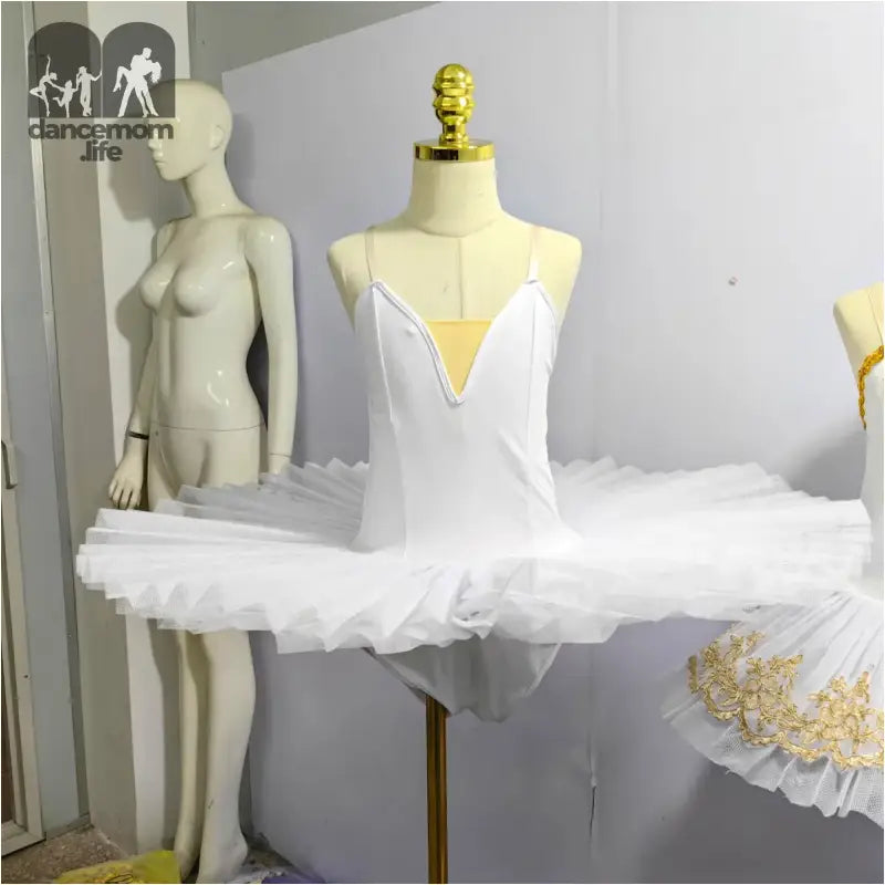 White classical ballet tutu with spaghetti straps and platter-style skirt.