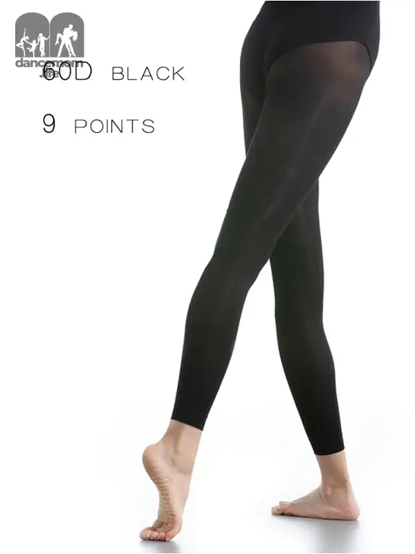 Black opaque footless tights or leggings worn on legs.