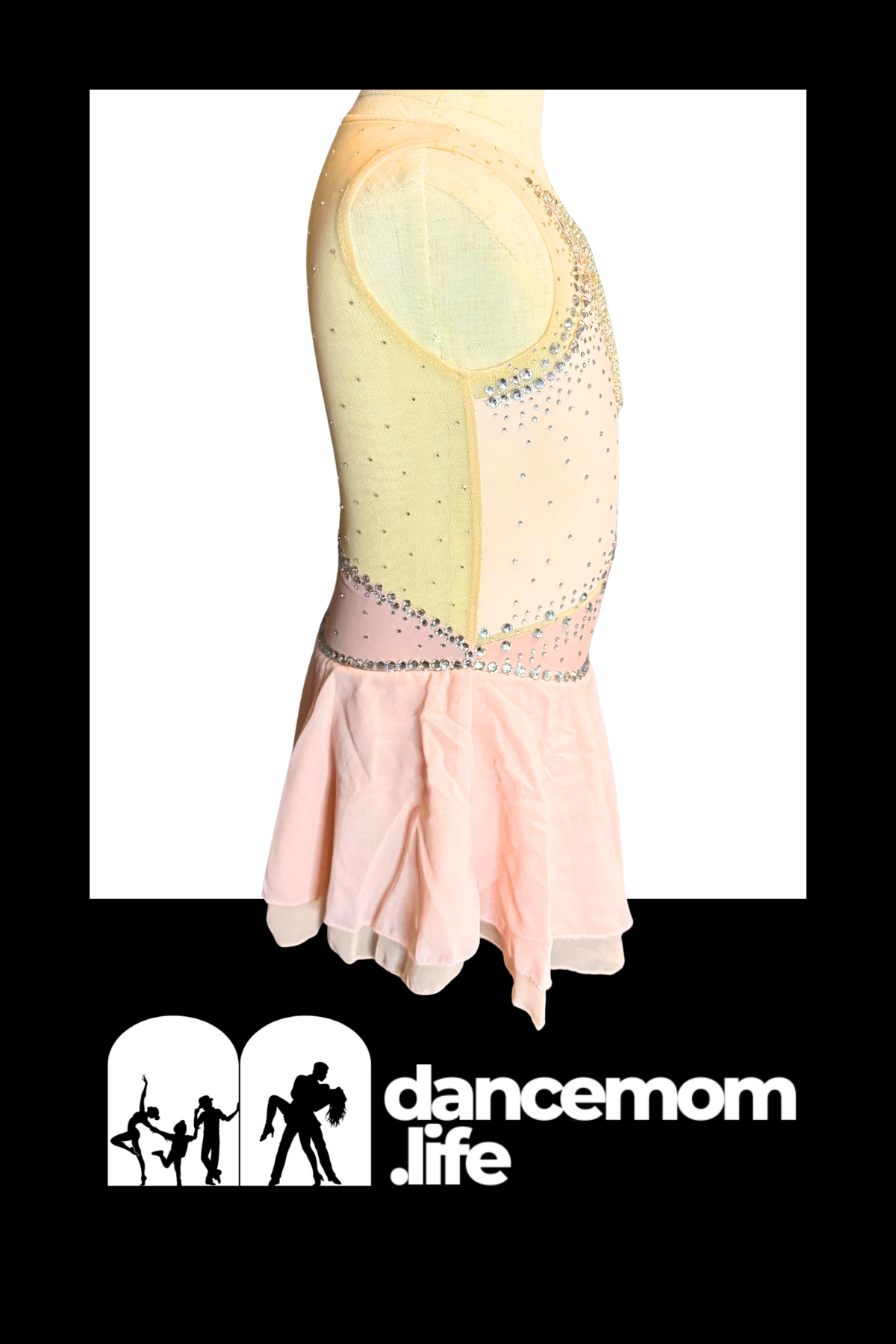 A pale pink, sleeveless dance leotard with a sheer mesh back and silver rhinestone embellishments along the shoulder line and waistband.