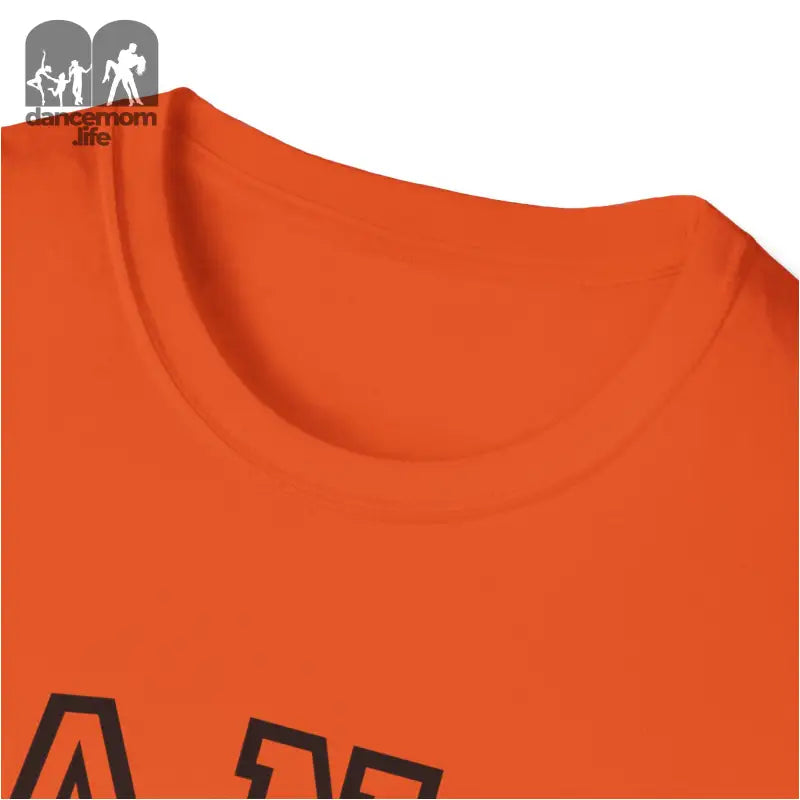 Orange t-shirt with a partial black text or design visible.