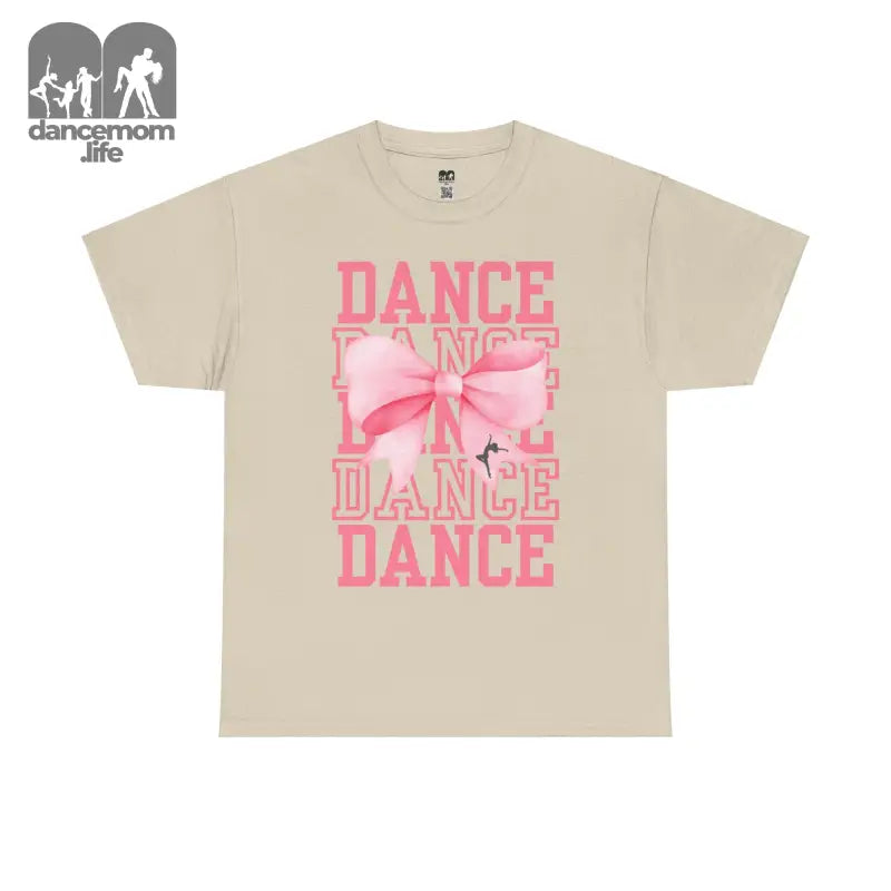 Beige t-shirt with pink ’DANCE’ text and bow design printed on the front.