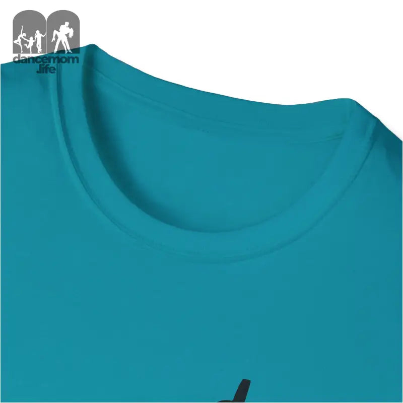 Teal-colored t-shirt neckline with a partial black graphic visible.