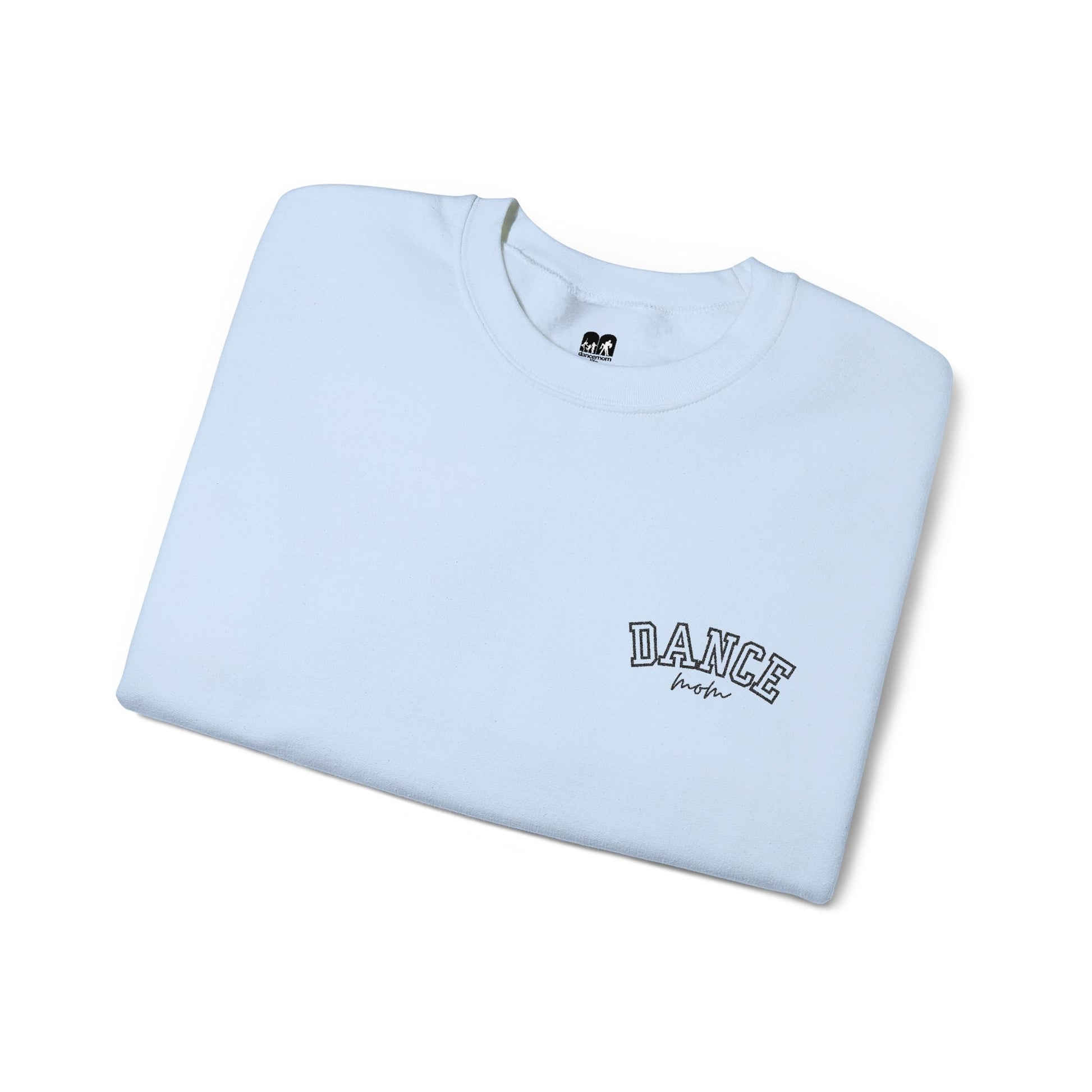A light blue crewneck t-shirt with ’dance’ embroidered in black arched lettering above a smaller cursive script.