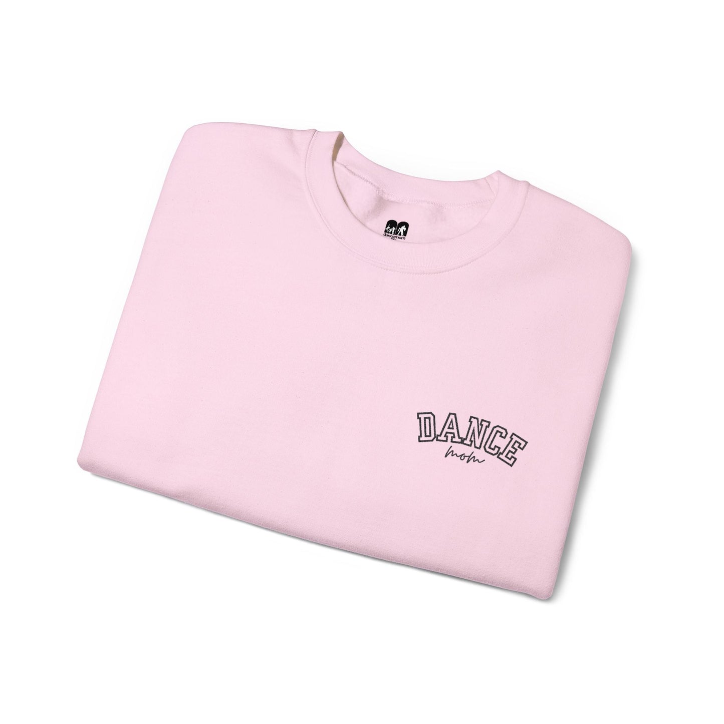 A soft pink crewneck sweatshirt with ’dance’ embroidered in black arched lettering above the word ’mom’ in a cursive script.