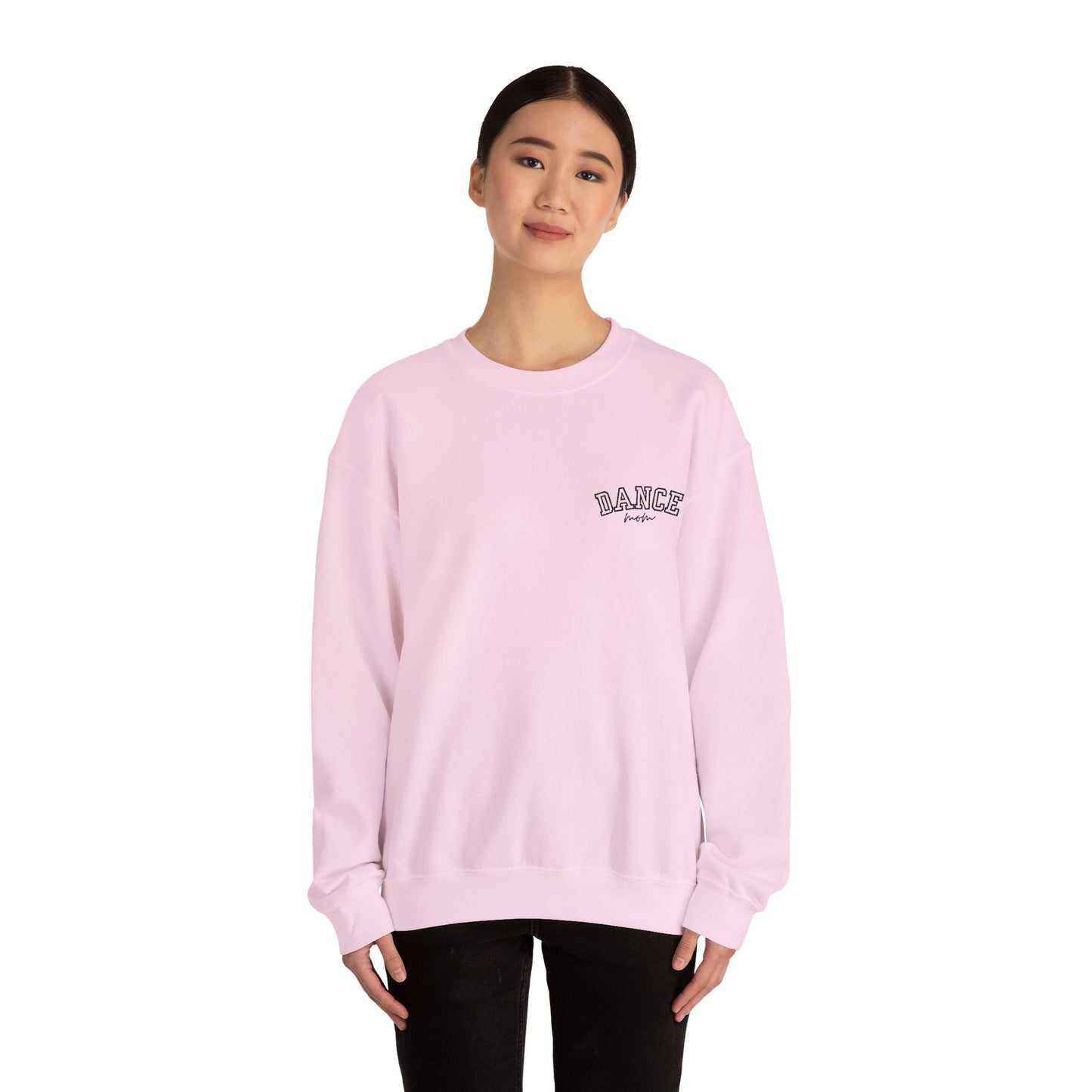 A soft pink, long-sleeved crewneck sweatshirt with a small embroidered ’dance’ logo on the left chest.