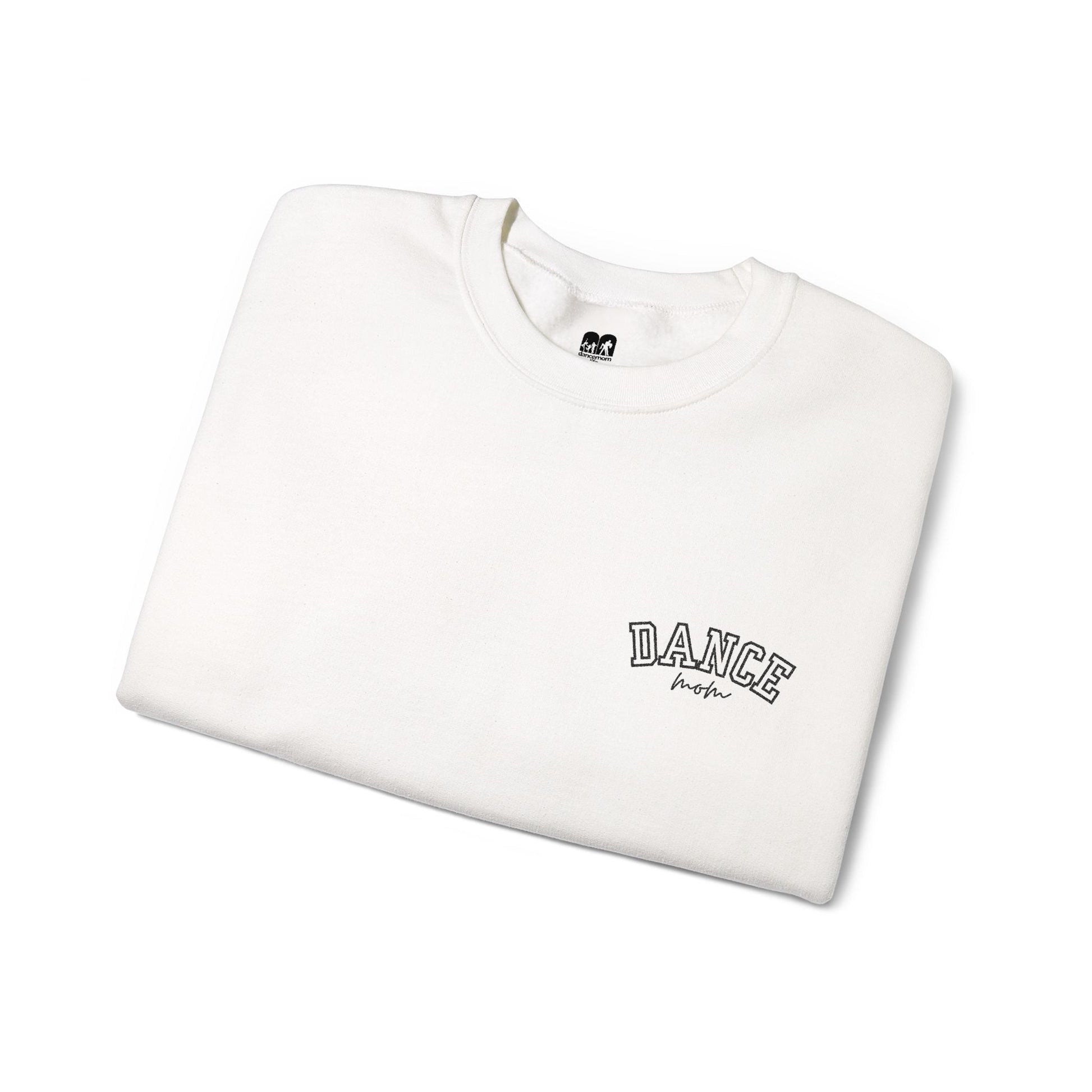 A white crewneck sweatshirt with ’dance’ embroidered in black arched lettering above the word ’mom’ in a cursive script.