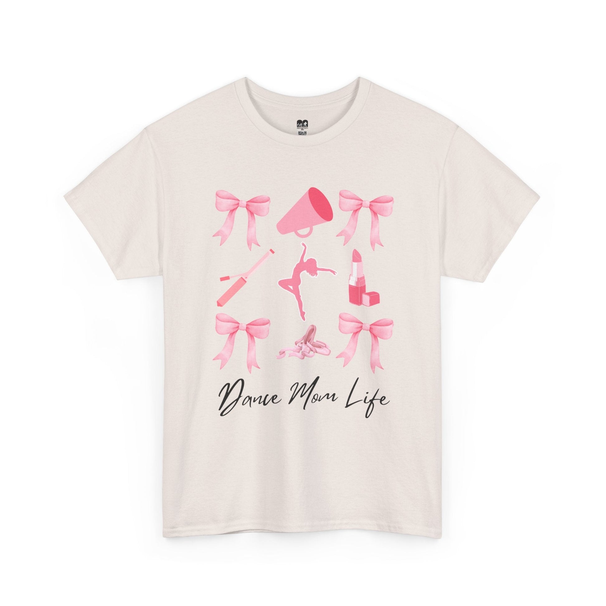 Cream-colored cotton t-shirt featuring a pink graphic of bows, a megaphone, ballet shoes, and lipstick with the text ’dance mom life’ in black cursive script.