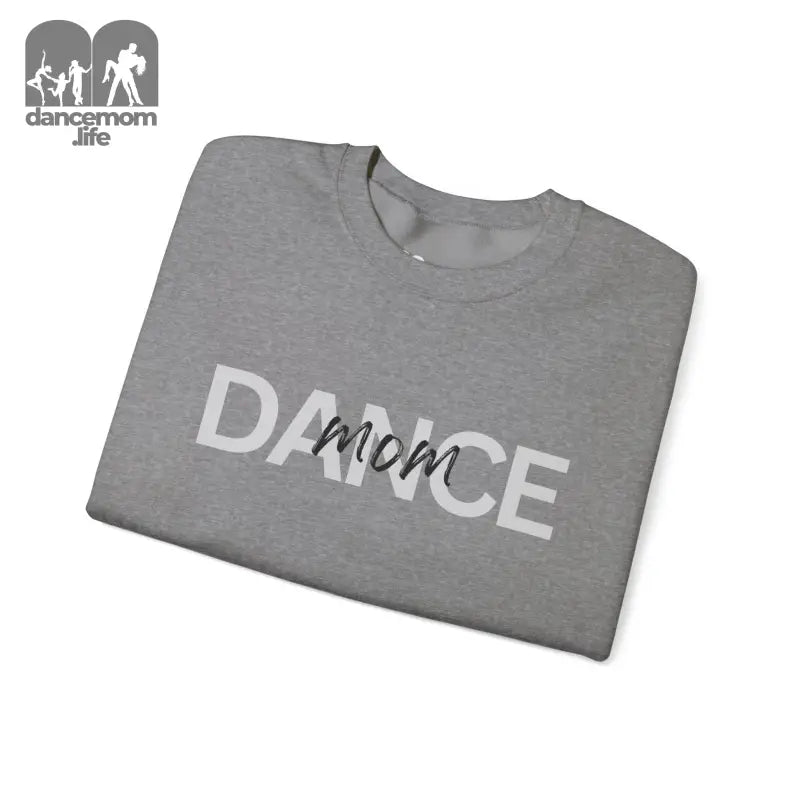 Grey folded t-shirt with ’DANCE mom’ text printed in white and black.