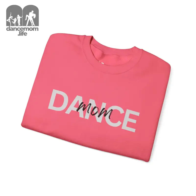 Pink sweatshirt with ’DANCE mom’ text printed on it.